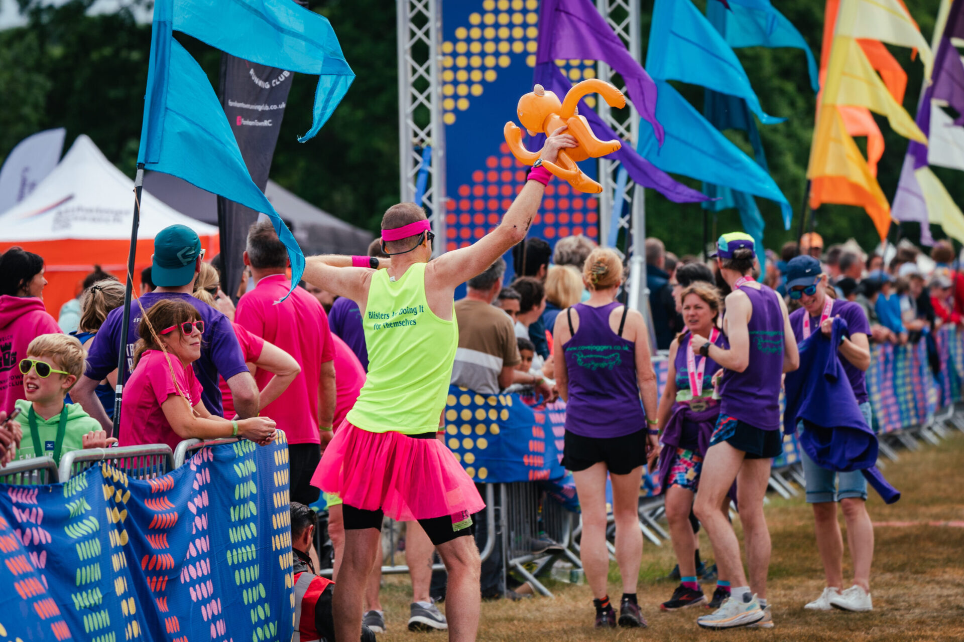 man in tutu holding inflatable prop at Endure24 as part of a team entry
